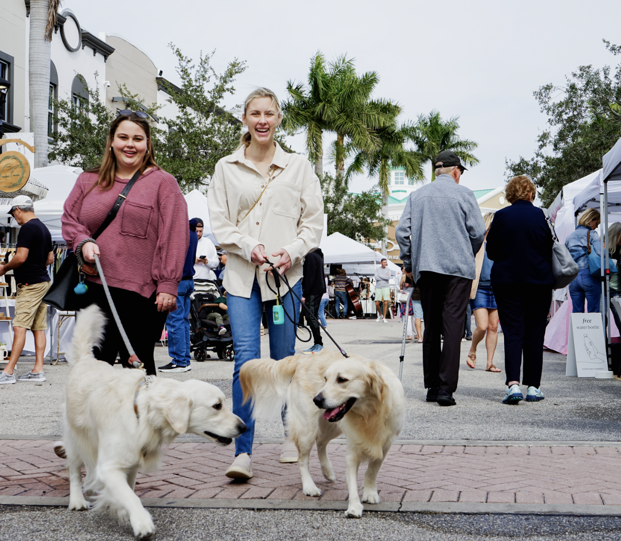 two women and their dogs attending Main Street Market